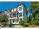 Attractive white modern home with covered front porch, balcony, and green front yard at 100 Villa Magnolia Ln, Alpharetta, GA 30009
