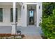 Charming covered front entry with modern, glass-paned door and views of the neighborhood at 100 Villa Magnolia Ln, Alpharetta, GA 30009