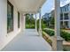 Spacious covered front porch with white columns and an extended view of the neighborhood at 100 Villa Magnolia Ln, Alpharetta, GA 30009