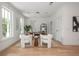 Bright home office with light wood floors, white walls, modern furniture and ample natural light at 100 Villa Magnolia Ln, Alpharetta, GA 30009