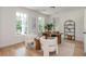Bright home office space with light wood floors, white walls, natural light and modern decor at 100 Villa Magnolia Ln, Alpharetta, GA 30009
