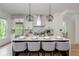 A kitchen boasting a large island with seating, stainless steel appliances, and modern geometric pendant lights at 100 Villa Magnolia Ln, Alpharetta, GA 30009