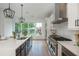 Modern kitchen with stainless steel appliances and a large center island with bar seating at 100 Villa Magnolia Ln, Alpharetta, GA 30009