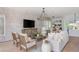 Bright living room featuring a whitewashed brick wall, decorative lighting, and hardwood floors at 100 Villa Magnolia Ln, Alpharetta, GA 30009