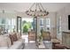 Open concept living room with hardwood floors, stylish lighting and access to outdoor balcony at 100 Villa Magnolia Ln, Alpharetta, GA 30009