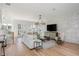 Bright living room featuring a white brick wall, wood floors, and comfortable seating area with modern decor at 100 Villa Magnolia Ln, Alpharetta, GA 30009