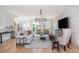 Living room with white brick accent wall, hardwood floors, and comfortable seating area at 100 Villa Magnolia Ln, Alpharetta, GA 30009