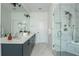 Luxurious bathroom with dual sinks, tiled shower, marble accents, modern fixtures, and a bright ambiance at 100 Villa Magnolia Ln, Alpharetta, GA 30009
