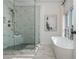 Modern main bathroom featuring a glass shower, soaking tub, marble tile, and a bright, airy feel at 100 Villa Magnolia Ln, Alpharetta, GA 30009