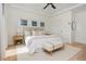 Well-lit main bedroom with a king bed, ceiling fan, neutral decor, and a bright, airy ambiance at 100 Villa Magnolia Ln, Alpharetta, GA 30009