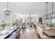 Open concept space with hardwood floors, brick accent wall, and dining area with modern lighting at 100 Villa Magnolia Ln, Alpharetta, GA 30009