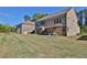 Large backyard view featuring a well-maintained lawn, rear of the house, and neighboring homes at 13015 Fox Rd, Alpharetta, GA 30005