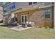 Backyard patio with awning, seating, and well-maintained lawn, perfect for outdoor relaxation at 13015 Fox Rd, Alpharetta, GA 30005