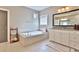 Relaxing bathroom with large soaking tub and tiled floor at 13015 Fox Rd, Alpharetta, GA 30005