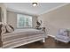 Cozy bedroom with large window, neutral colors, and space for exercise equipment at 13015 Fox Rd, Alpharetta, GA 30005