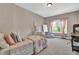 Cozy bedroom featuring a comfortable bed, a window with natural light, and desk at 13015 Fox Rd, Alpharetta, GA 30005