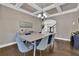 Bright dining room with stylish decor, coffered ceiling, hardwood floors, and modern lighting at 13015 Fox Rd, Alpharetta, GA 30005