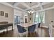 Elegant dining room with coffered ceilings, hardwood floors, and a stylish light fixture at 13015 Fox Rd, Alpharetta, GA 30005