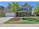 Charming two-story brick home featuring a manicured front yard and attached two-car garage at 13015 Fox Rd, Alpharetta, GA 30005