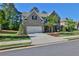 Inviting two-story home with a brick exterior, landscaped front yard, and a spacious driveway at 13015 Fox Rd, Alpharetta, GA 30005