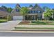 Charming home featuring a brick facade, well-manicured lawn, and a two-car garage at 13015 Fox Rd, Alpharetta, GA 30005