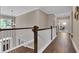 Upstairs hallway with hardwood floors and a view of the staircase and chandelier at 13015 Fox Rd, Alpharetta, GA 30005
