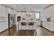 Modern kitchen with white cabinets, granite countertops, stainless steel appliances, and a central island at 13015 Fox Rd, Alpharetta, GA 30005