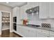 Stylish kitchen with white cabinets, granite countertops, and stainless steel appliances at 13015 Fox Rd, Alpharetta, GA 30005