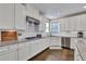 Elegant kitchen with white cabinets, granite countertops, and stainless steel appliances at 13015 Fox Rd, Alpharetta, GA 30005