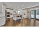 Bright kitchen features white cabinets, granite counters, a central island and stainless steel appliances at 13015 Fox Rd, Alpharetta, GA 30005