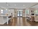 Open concept kitchen and living room features hardwood floors and a cozy fireplace at 13015 Fox Rd, Alpharetta, GA 30005