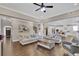Spacious living room with dark wood floors and an open layout to the kitchen at 13015 Fox Rd, Alpharetta, GA 30005