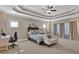 Spacious main bedroom features a tray ceiling, large windows, and a seating area at 13015 Fox Rd, Alpharetta, GA 30005