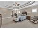 Spacious main bedroom with tray ceiling, ceiling fan, sitting area, and ensuite bathroom and office at 13015 Fox Rd, Alpharetta, GA 30005
