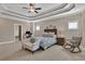Spacious main bedroom with tray ceiling, ceiling fan, sitting area, and ensuite bathroom and office at 13015 Fox Rd, Alpharetta, GA 30005