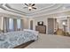 Spacious main bedroom with tray ceiling, ceiling fan, large windows and an ensuite bathroom at 13015 Fox Rd, Alpharetta, GA 30005