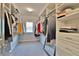 Well-organized walk-in closet with ample hanging space, shelves, and drawers for storage at 13015 Fox Rd, Alpharetta, GA 30005