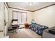 A cozy bedroom featuring a bed, a window, and an office chair next to a nightstand at 3514 Blackberry Se Ln, Conyers, GA 30094