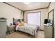 Comfortable bedroom featuring floral bedding, window with curtain, and matching nightstands at 3514 Blackberry Se Ln, Conyers, GA 30094