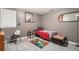 Bedroom with gray walls, light vinyl floors, and a playful rug, creating a cozy atmosphere at 3514 Blackberry Se Ln, Conyers, GA 30094