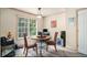 Bright breakfast nook with a cozy round table, a computer workstation and natural light from the large window at 3514 Blackberry Se Ln, Conyers, GA 30094