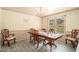 Formal dining room with classic wood furniture, chandelier lighting, and large windows at 3514 Blackberry Se Ln, Conyers, GA 30094