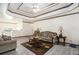Bright living room featuring elegant tray ceilings, neutral tones, and comfortable seating at 3514 Blackberry Se Ln, Conyers, GA 30094