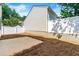 View of the home's backyard featuring a concrete patio and white fencing at 486 Windcroft Nw Cir, Acworth, GA 30101