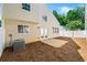 Backyard with patio, freshly mulched ground, surrounded by a white vinyl fence and mature trees at 486 Windcroft Nw Cir, Acworth, GA 30101