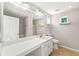 A bathroom featuring a wide mirror above a vanity, with a bath and shower combination visible behind it at 486 Windcroft Nw Cir, Acworth, GA 30101