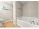 A bright bathroom with a soaking tub, tile flooring, and neutral colored walls at 486 Windcroft Nw Cir, Acworth, GA 30101