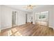 A bedroom showcasing hardwood floors, ceiling fan, mirrored closet and convenient access to adjacent rooms at 486 Windcroft Nw Cir, Acworth, GA 30101