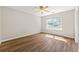 Bedroom with a ceiling fan, window with natural light, and wood-look flooring at 486 Windcroft Nw Cir, Acworth, GA 30101