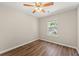 A cozy bedroom featuring wood-look flooring, a ceiling fan with lights, and a window at 486 Windcroft Nw Cir, Acworth, GA 30101